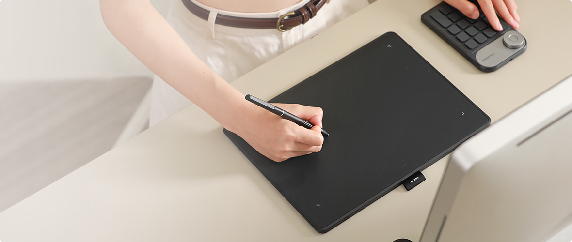 Huion Inspiroy Frego tablet in a creative workspace